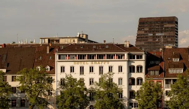 Nineteenth-century hotel front of pale stone facing a river embankment