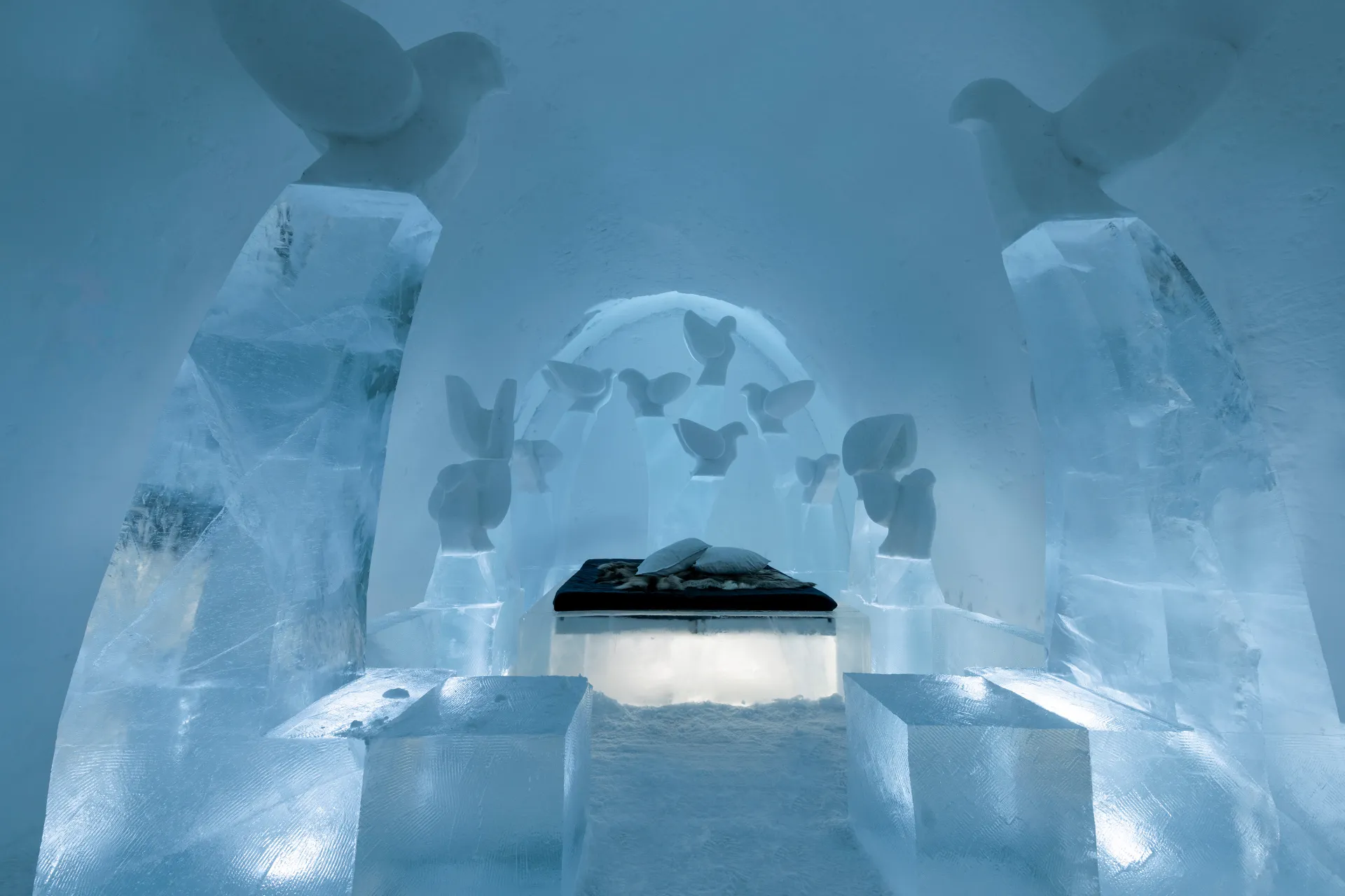 Vaulted hall of clear ice and packed snow with carved openings on both sides