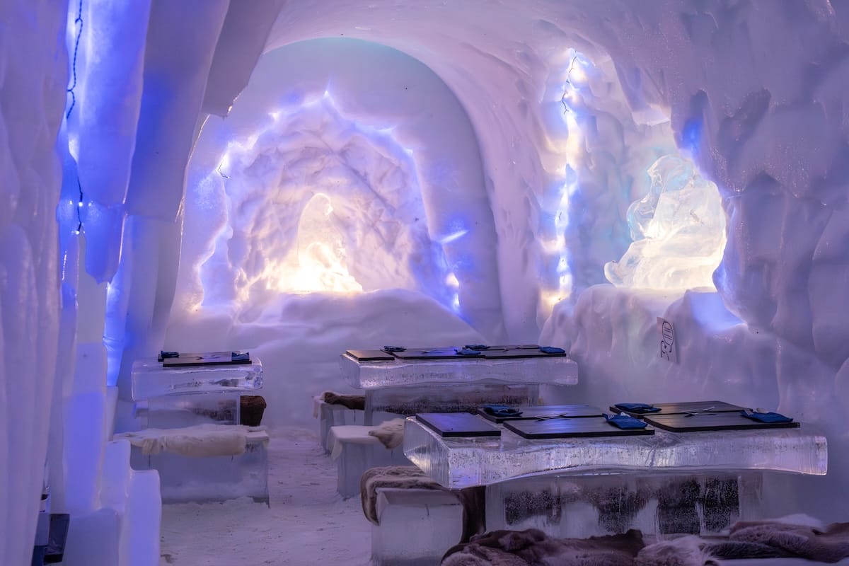 Carved chamber of ice and snow with a low bed platform under a vaulted roof