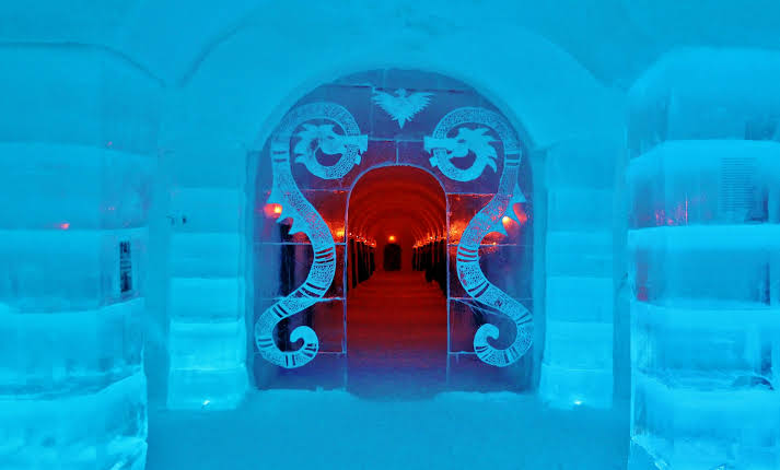 Corridor of packed snow with carved openings leading to sleeping chambers