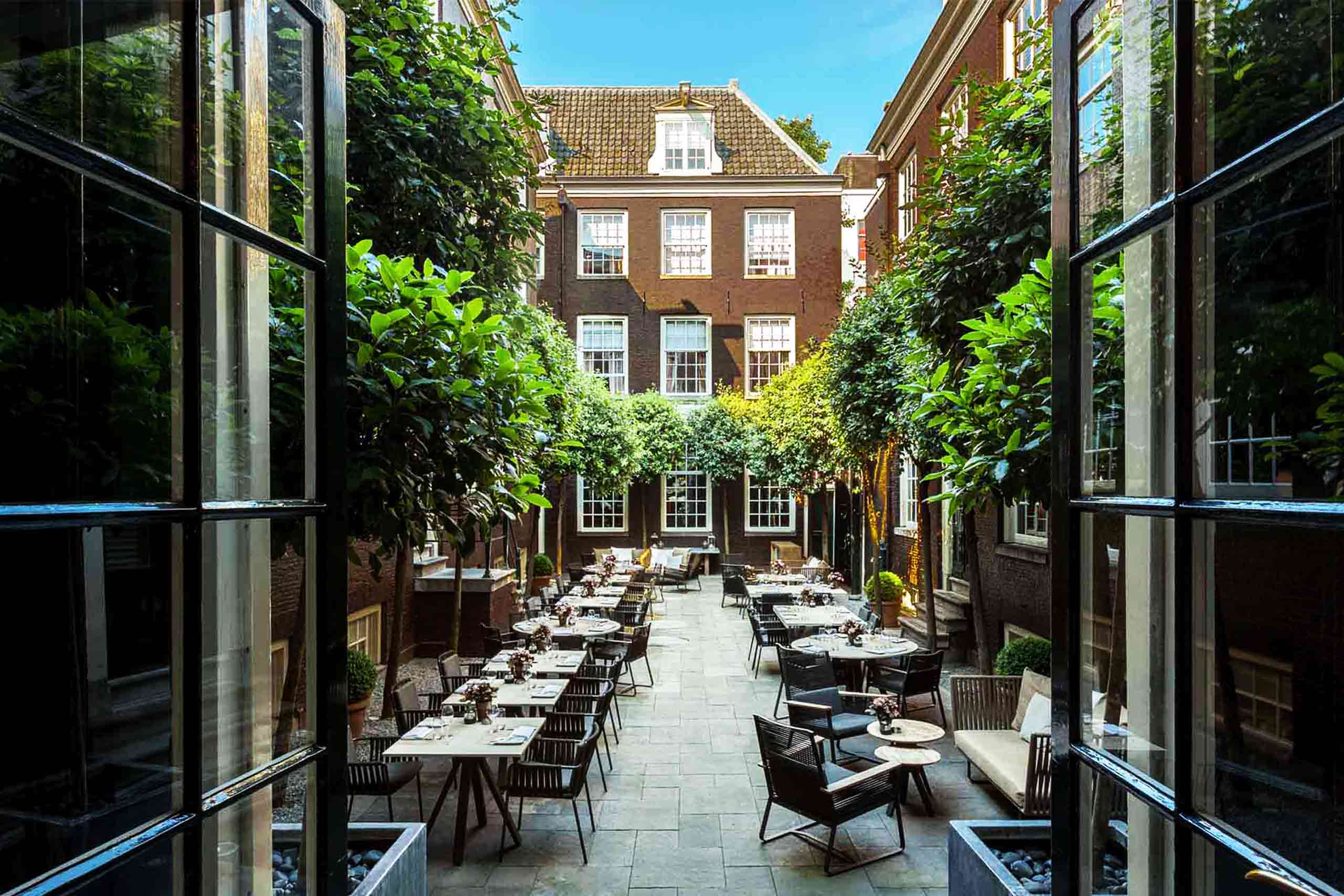 Brick canal houses around a paved inner courtyard entered through a stone gateway